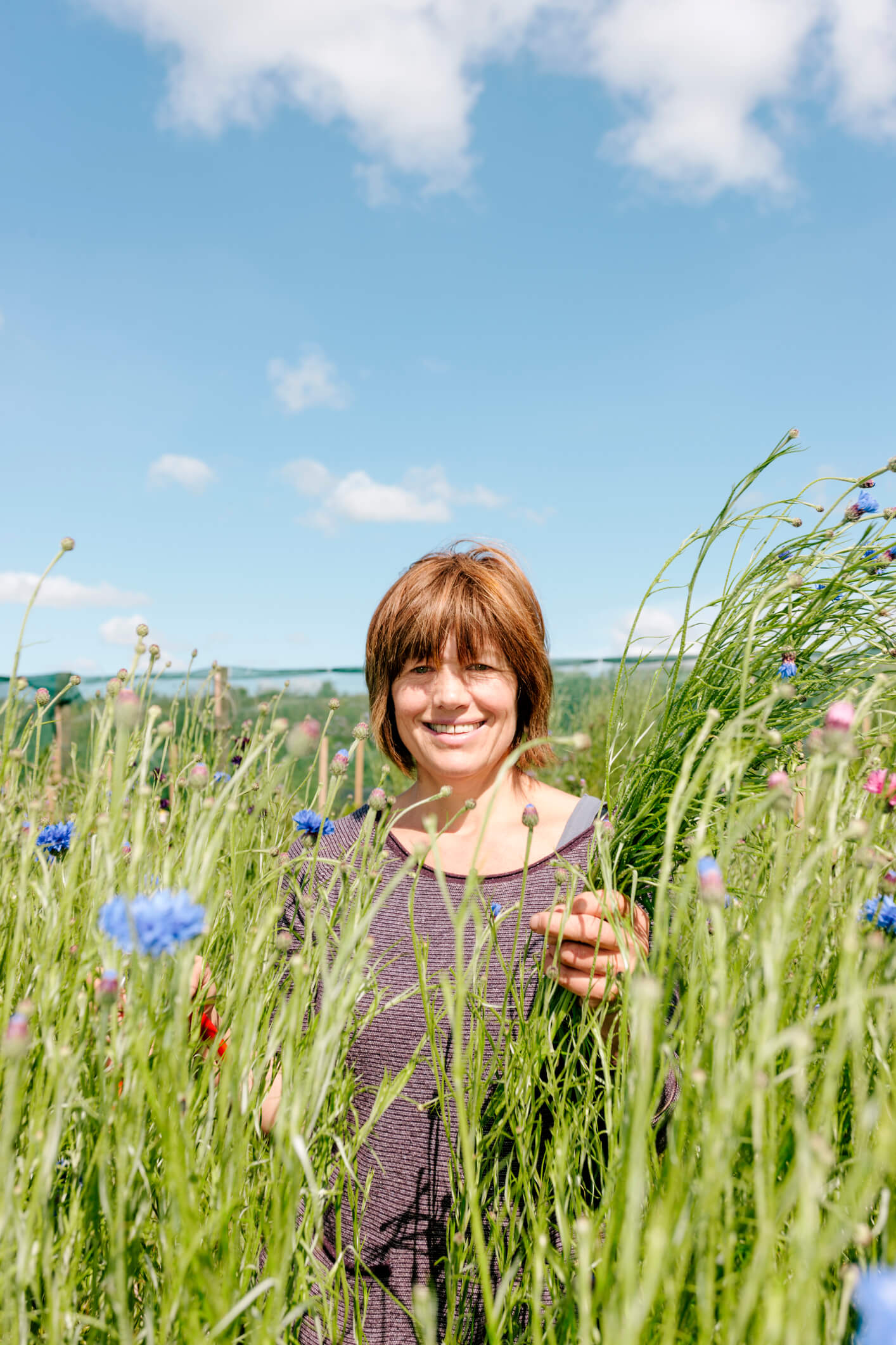 Lady standing in a field of tall grass
